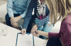 Couple-signing-documents
